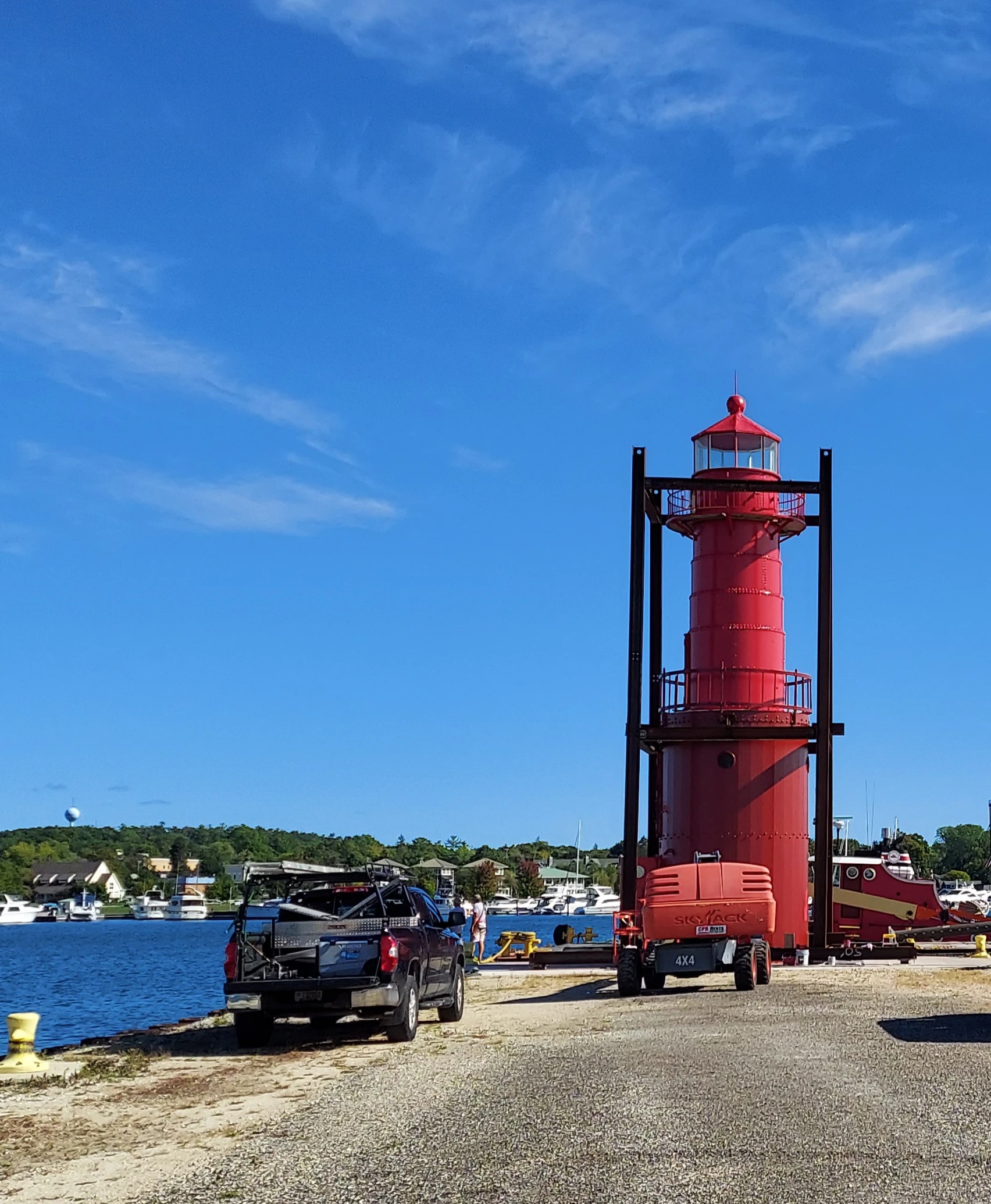 Cylindrical metal tower, standing on the waterfront, blue sky